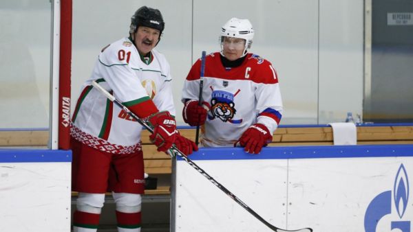This file photo taken on February 7, 2020 shows Russian President Vladimir Putin (R) and Belarusian President Alexander Lukashenko stepping onto the ice as they take part in an ice hockey match at Rosa Khutor outside the Black Sea resort of Sochi. Belarusian President Alexander Lukashenko discussed the protests shaking his country with Russian counterpart Vladimir Putin on August 15, Belarusian state news agency Belta reported. Alexander Zemlianichenko / POOL / AFP