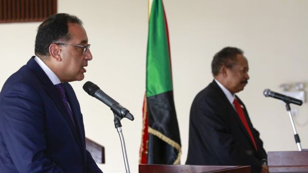 Egyptian Prime Minister Mostafa Madbouli (L) and his Sudanese counterpart Abdalla Hamdok address the press after their meeting in Sudan's capital Khartoum, on August 15, 2020. ASHRAF SHAZLY / AFP