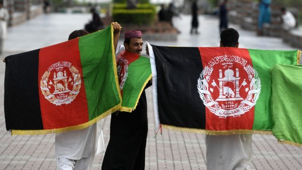 Afghan tourists hold their national flags as they visit Rawal Lake park in Islamabad on August 19, 2020, after the government announced most of the country's remaining restrictions would be lifted following the drop in new COVID-19 coronavirus cases for several weeks. Aamir QURESHI / AFP