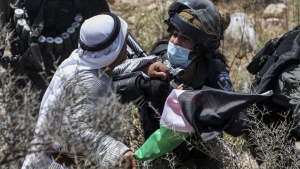 A Palestinian protester argues and scuffles with an Israeli soldier, mask-clad due to the COVID-19 coronavirus pandemic, near the village of Shoufah, southeast of Tulkarm in the occupied West Bank on August 20, 2020, amidst a protest against the clearing of lands to expand Israeli settlements. JAAFAR ASHTIYEH / AFP