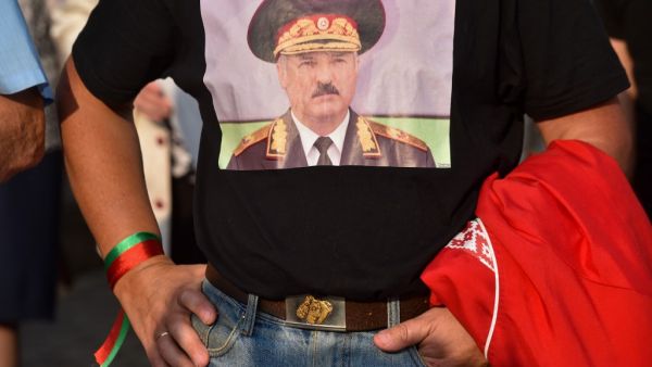 A man wearing a T-shirt with an image of Belarusian President Alexander Lukashenko attends a rally of Lukashenko's supporters in Minsk on August 21, 2020. Belarusian President Alexander Lukashenko vowed on August 21 to resolve his country's political crisis "in the coming days" and accused the United States of "directing" anti-government protesters. Lukashenko is facing the biggest challenge to his 26-year rule after thousands of protesters took to the streets to denounce his claim to have won a sixth term 