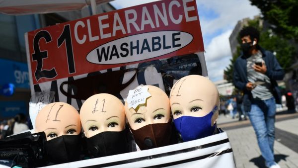 Protective face masks are seen for sale in Birmingham, central England on August 22, 2020, as Britain's second-city, home to more than one million people, was made an "area of enhanced support", because of concern about a spike in cases of the novel coronavirus. JUSTIN TALLIS / AFP