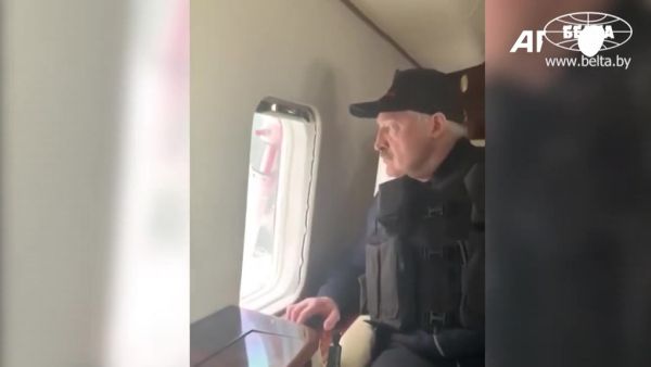 This grab taken from a video released by Belarus state agency "Belta" shows President Alexander Lukashenko wearing a body armour in his helicopter as he arrives, on August 23, 2020, at his residence in Minsk. Tens of thousands of demonstrators massed in central Minsk on Sunday to demand the resignation of Belarusian President Alexander Lukashenko, who flew over the scene of the banned protest in a helicopter and called the marchers "rats". BELTA / AFP