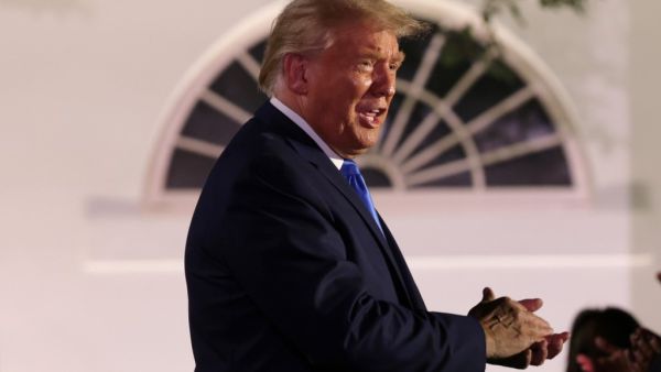 U.S. President Donald Trump applauds as he arrives to listen to first lady Melania Trump's address to the Republican National Convention from the Rose Garden at the White House on August 25, 2020 in Washington, DC. The convention is being held virtually due to the coronavirus pandemic but will include speeches from various locations including Charlotte, North Carolina and Washington, DC. Alex Wong/Getty Images/AFP ALEX WONG / GETTY IMAGES NORTH AMERICA / Getty Images via AFP