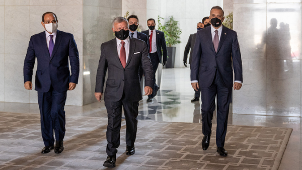 Jordanian King Abdullah, center, arrives with Egyptian President Abdel Fattah El-Sisi, left, and Iraqi Prime Minister Mustafa Al-Kadhimi at the summit in Amman. (AFP)