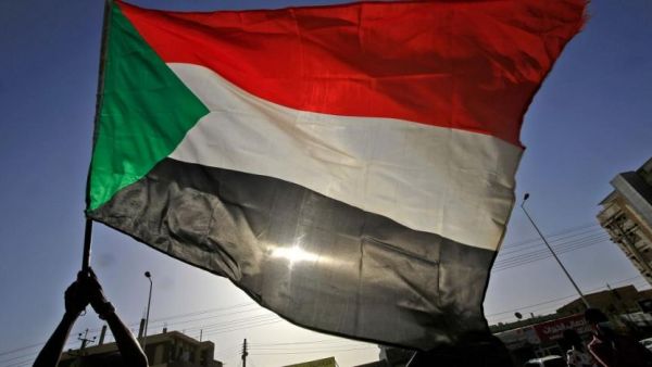 A protester waves a national flag during an anti-government demonstration in Khartoum in June 2020. (AFP)