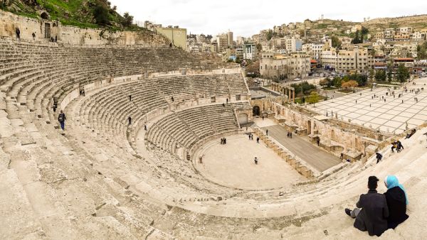 View from the top of the Roman Theatre, with tourists visiting and wandering around the roman ruins of Amman  (Shutterstock)	