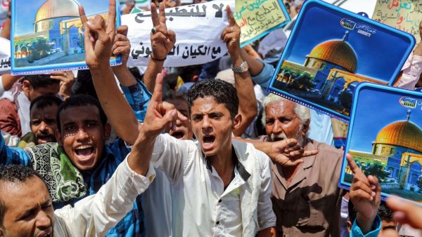 Demonstrators chant slogans with signs depicting Jerusalem's Dome of the Rock alongside other signs reading in Arabic "no to normalisation with the Zionist entity", during a protest in Yemen's third city of Taez on August 21, 2020, against the US-brokered deal between the United Arab Emirates and Israel to normalise relations. AHMAD AL-BASHA / AFP