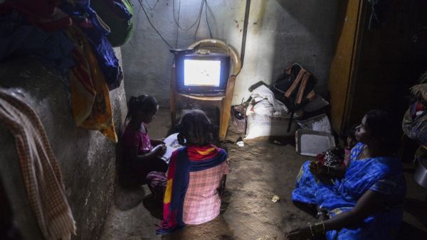 Government Primary School students follow the e-education classes telecasted on the T-SAT Network and Doordharshan TV network channels as their mum watches at their home in Nagireddypally village of Siddipet District, some 50 kms from Hyderabad on September 1, 2020. The Telangana State Education Board started on September 1 its alternative 2020-2021 academic year e-education system through the T-SAT Network and Doordharshan TV network due to the Covid-19