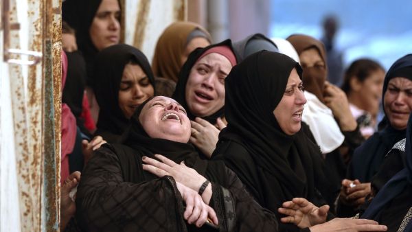 Palestinian women mourn during the funeral of three children who were killed in a fire ignited by a candle used to light up their room during a power cut in al-Nusirat refugee camp in the central Gaza Strip on September 2, 2020.MAHMUD HAMS / AFP