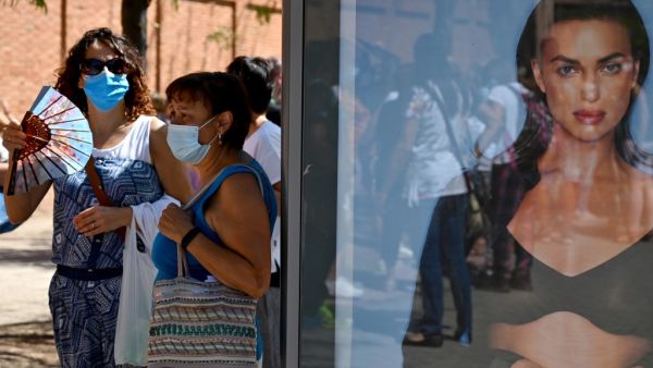Teachers and nonacademic personnel queue to undergo PCR tests outside the Virgen de la Paloma high school, ahead of the reopening of schools for a new academic year amid the coronavirus pandemic, in Madrid on September 2, 2020. Gabriel BOUYS / AFP