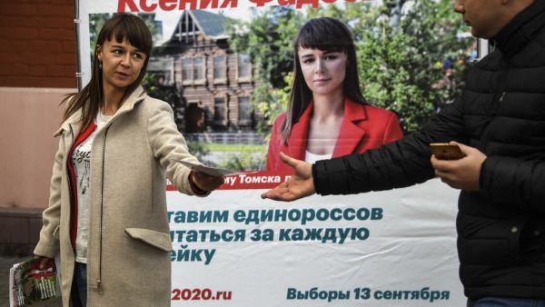 Ksenia Fadeyeva, 28, the head of Alexei Navalny's Tomsk headquarters and the city council candidate in September 13 regional elections, distributes campaign leaflets in the Siberian city of Tomsk on September 7, 2020. Alexander NEMENOV / AFP