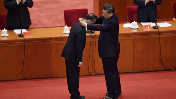 Chinese medical expert Zhong Nanshan (L) receives an award from Chinese President Xi Jinping during a ceremony to honour people who fought against the COVID-19 coronavirus pandemic, at the Great Hall of the People in Beijing on September 8, 2020. NICOLAS ASFOURI / AFP