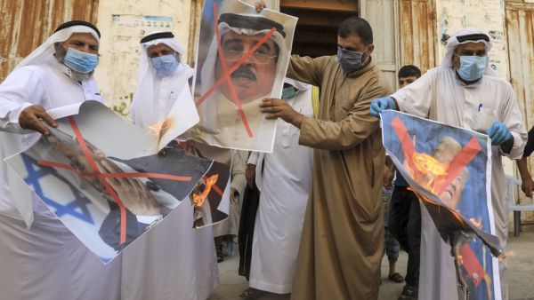 Palestinian men burn the exed out portraits of the Bahraini King, US President and Israeli Premier during a protest in Deir al-Balah, in central Gaza Strip, on September 12, 2020, to condemn the normalisation of ties between Israeli and Bahrain. The Palestinian cause has long cemented ties between Middle East nations with divergent interests, but amid shifting regional alliances they are increasingly isolated and in need of new friends, analysts say. In the latest blow, Bahrain broke ranks and agreed on Fri