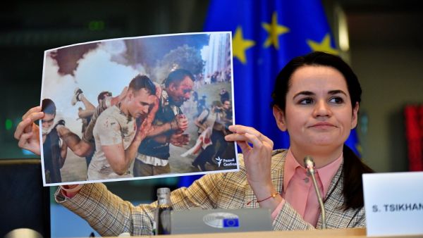 Belarus opposition leader Svetlana Tikhanovskaya holds up a photograph as she addresses members of the EU parliament at the EU headquarters in Brussels on September 21, 2020. European foreign ministers welcomed Belarus opposition leader Svetlana Tikhanovskaya to Brussels as they prepare EU sanctions to support her battle against the Minsk regime. The former Soviet republic has been convulsed by unprecedented demonstrations against President Alexander Lukashenko since he was returned to power in a disputed A