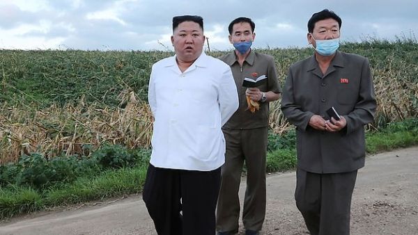 North Korean leader Kim Jong Un, pictured, has ordered soldiers and police to 'shoot on sight' anyone within half a mile of the country's border with China in a bid to stop the spread of coronavirus (AFP)