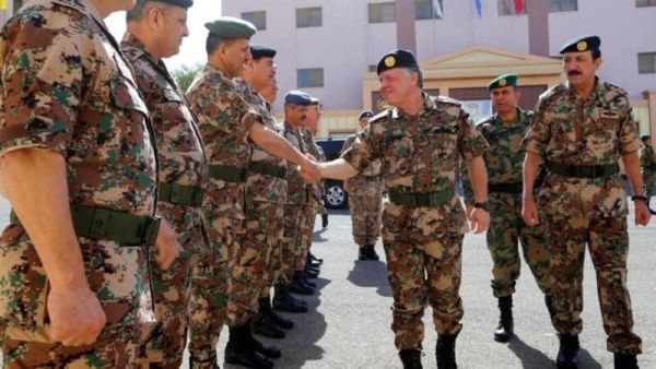 King Abdullah II shaking hands with members of the Jordanian army (AFP)
