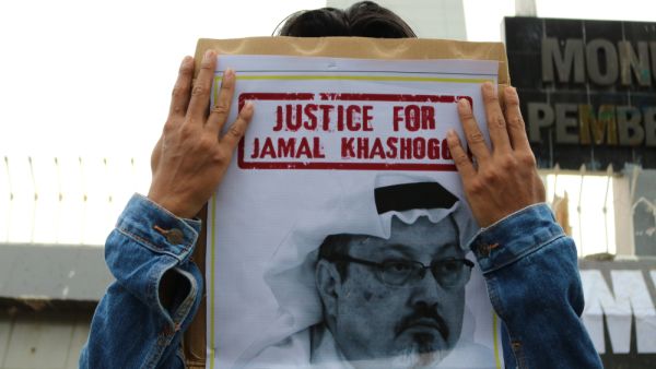 Humanitarian activists hold a poster with a picture of Jamal Khashoggi demonstrating in Makassar. (Shutterstock/ File Photo)