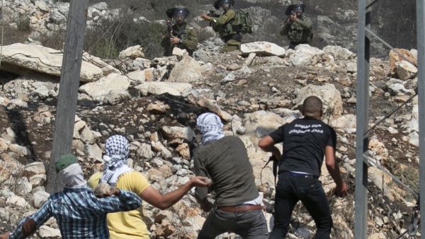Palestinian protesters hurl stones at Israeli security forces during a demonstration in the village of Kfar Qaddum on September 25, 2020. (AFP/File Photo)