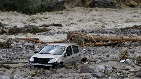 A car lies in mud after being moved by the floods of the Vesubie river in Roquebilliere, southeastern France, on October 3, 2020. after heavy rains and floodings hit the Alpes-Maritimes department. Heavy rains and brutal floods have left villages cut off from the world in the Alpes Maritimes, where hundreds of fire-fighters have been mobilised on October 3, to find nine missing persons. NICOLAS TUCAT / AFP