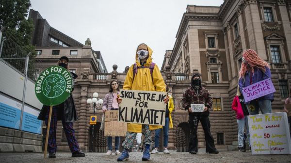 Swedish climate activist Greta Thunberg protests with her placard reading "School strike for climate" as part of her Fridays for Future protest in front of the Swedish Parliament Riksdagen in Stockholm on October 9, 2020. Jonathan NACKSTRAND / AFP