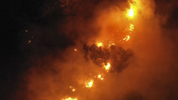 An aerial picture shows flames engulfing trees as a forest fire rages in Lebanon's Ras El Metn area, on October 10, 2020. AFP