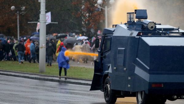 Police use a water cannon truck to disperse demonstrators during a rally to protest against the Belarus presidential election results in Minsk on October 11, 2020. Riot police swiftly detained dozens at a protest march in Belarus on October 11 after strongman leader raised hopes for change by meeting jailed opposition figures. STRINGER / AFP