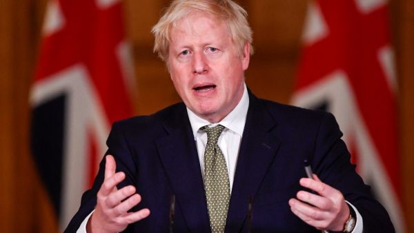 Britain's Prime Minister Boris Johnson gestures as he speaks during a virtual press conference inside 10 Downing Street in central London on October 12, 2020. (AFP/File)