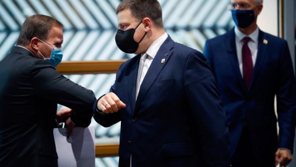 Sweden's Prime Minister Stefan Lofven (L) greets Estonia's Prime Minister Juri Ratas (C) with an elbow bump next to Latvia's Prime Minister Arturs Krisjanis Karins prior a North Baltic countries meeting on the sidelines of a two days European Union (EU) summit at the European Council Building in Brussels, on October 15, 2020. (AFP/File)