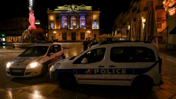 French Police officers stand next to their cars in Montpellier on October 17, 2020, as a curfew is in place to fight the spread of Covid-19. About 20 million people in the Paris region and eight other French cities were facing a 9 pm-6 am curfew from October 17, after cases surged in what has once again become one of Europe's major hotpots. Pascal GUYOT / AFP