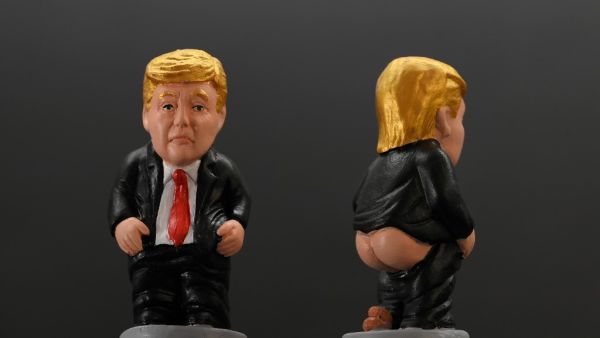 A picture shows typical Catalan ceramic figurines called "caganers" (poopies) depicting US President Donald Trump in Barcelona on October 22, 2022. Statuettes of well-known people defecating are a strong Christmas tradition in Catalonia, dating back to the 18th century as Catalans hide "caganers" in Christmas Nativity scenes and invite friends to find them. LLUIS GENE / AFP