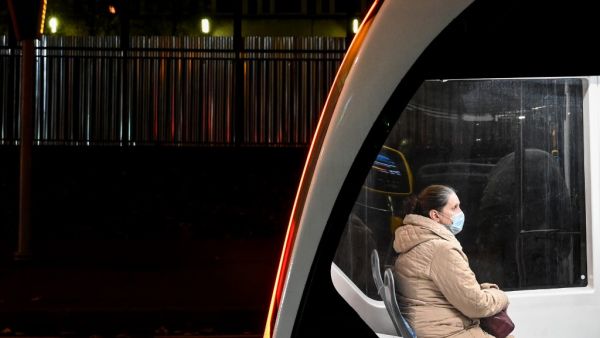 A woman wearing a face mask to protect against the Covid-19 disease uses a tram in Moscow on October 23, 2020, amid the ongoing coronavirus pandemic. Russia confirmed 17,340 new Covid-19 daily cases including 5,478 in Moscow on October 23, 2020. Kirill KUDRYAVTSEV / AFP