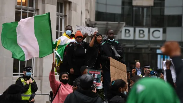 Protestors shout slogans during a protest action against police brutality in Nigeria, outside the BBC offices in central London on October 24, 2020. UN Secretary General Antonio Guterres has called for an end to what he called "brutality" by police in Nigeria, which has been rocked by two weeks of protests. Guterres said gunmen that opened fire on peaceful protesters Tuesday evening in Lagos caused "multiple deaths" and many injuries. DANIEL LEAL-OLIVAS / AFP