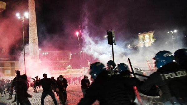 Italian police officers clash with far right Forza Nuova party activists during a protest against the government restriction measures to curb the spread of COVID-19, at central Piazza del Popolo, in Rome, Italy on October 24, 2020. Following last spring lockdown, Italy is facing its worst post-war economic recession. The country has recorded nearly 500,000 positive cases to the Covid-19 since the start of the pandemic, including 37,059 deaths, according to the Italian Ministry of Health on October 24, 2020 