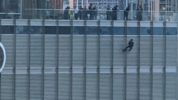 On Sunday a man was seen dangling from a rope outside the 16th floor of Trump Tower in downtown Chicago. (Twitter)