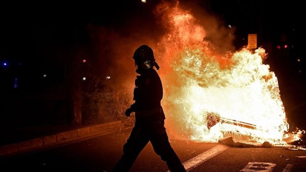 Protests erupted across Italy and Spain last night as thousands of angry demonstrators called on their Governments to reconsider a second-round of lockdown restrictions. Vast crowds gathered on the streets of Barcelona with angry protesters setting dustbins on fire  (AFP)