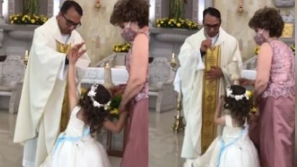 'Give me a high five, father': A little girl high-fived a priest as he was trying to give her a blessing. The priest struggled to contain his laughter after the adorable incident. (TikTok)