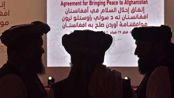 Members of the Taliban delegation gather ahead of Saturday's signing ceremony with the United States in the Qatari capital of Doha. Giuseppe Cacace/AFP via Getty Images