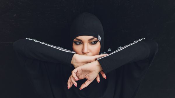Muslim asian woman in hijab exercizing in a gym (Shutterstock)