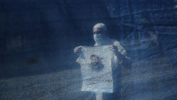 A protester holds a poster of Palestinian prisoner in an Israeli jail Maher Al-Akhras, who is in a hunger strike for 80 days, inside a solidarity tent next to the International Committee of the Red Cross building in Gaza City, on October 14, 2020. MOHAMMED ABED / AFP