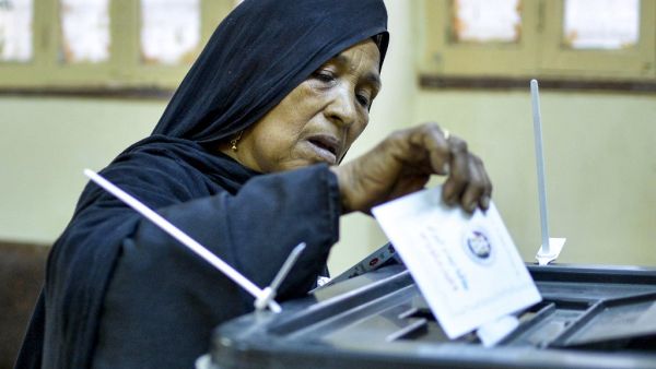A woman voter casts her ballot at a polling station in Esna, about 55 kilometres south of Egypt's southern city of Luxor October 24, 2020, during the first stage of the lower house elections. Polling stations opened in Egypt for parliamentary elections in which there was little doubt of a sweeping victory for supporters of hardline President Abdel Fattah al-Sisi. Some 63 million voters out of Egypt's more than 100 million people are eligible to elect 568 of the 596 lawmakers in the lower house, widely seen 