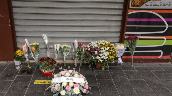 Flowers have been laid outside the restaurant where Brazilian Simone Barreto Silva took refuge after being stabbed several times but died of her wounds there, near the Notre-Dame de l'Assomption Basilica in Nice on October 31, 2020. (AFP)