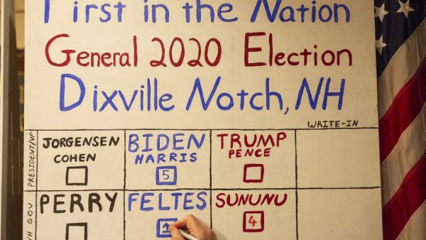 The votes are tallied, five in favor of Former vice-president and Democratic presidential nominee Joe Biden against zero for US President Donald Trump during the historic midnight vote at the Hale House at the historic Balsams Resort during midnight voting as part of the first ballots cast in the United States Presidential Election in Dixville Notch, New Hampshire on November 3, 2020. Voters in Dixville Notch, a village of 12 residents in the US state of New Hampshire, kicked off Election Day at the stroke 