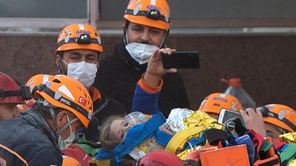Rescue workers carry three-year-old girl Ayda Gezgin as they pull her out of the rubble of a building 91 hours after it collapsed during a 7.0-magnitude earthquake, at Bayrakli district in Izmir, on November 3, 2020. (AFP)