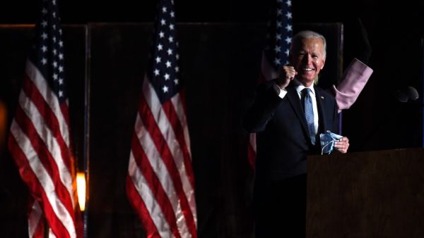 Democratic presidential nominee Joe Biden (L) and wife Jill Biden arrive onstage to address supporters during election night at the Chase Center in Wilmington, Delaware, early on November 4, 2020. Roberto SCHMIDT / AFP
