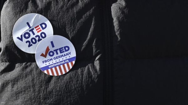 A member of the "Democrats Abroad" organisation wears an "I voted 2020" sticker during a demonstration near the US embassy in Berlin on November 4, 2020, as votes' counting continues in the current presidential election. The US election was plunged into chaos early Wednesday November 4, 2020, as President Donald Trump prematurely declared victory and sought Supreme Court intervention to stop vote-counting -- even as his Democratic rival Joe Biden voiced confidence in his own chances. John MACDOUGALL / AFP