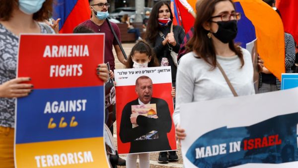 Members of the Armenian community in Israel hold banners in the coastal city of Tel Aviv on November 6, 2020, as they protest against Israel's arms sales to Azerbaijan and Turkey's support to the latter. JACK GUEZ / AFP