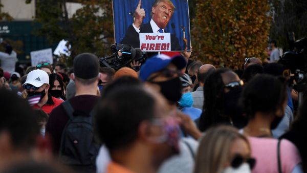 Supporters of president-elect Joe Biden celebrates on Black Lives Matter plaza across from the White House in Washington, DC on November 7, 2020, after Joe Biden was declared the winner of the 2020 presidential election. (AFP/File Photo)