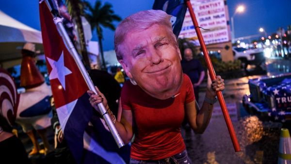 Trump supporters hold signs and flags during a protest in Miami on November 7, 2020, after Joe Biden was declared the winner of the presidential election.  CHANDAN KHANNA / AFP