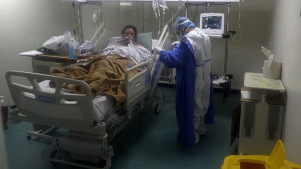 A nurse takes care of a COVID-19 patient in the intensive care unit of the Rafic Hariri University Hospital in the Lebanese capital Beirut, on November 13, 2020. In Lebanon, where hospital capacity has been saturated, coronavirus infections crossed the 100,000 mark as the country prepared to enter a new two-week lockdown. The health ministry said the number of people who have tested positive with Covid-19 had reached 100,703, including 775 deaths.  JOSEPH EID / AFP